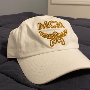 White canvas hat with gold embroidered logo